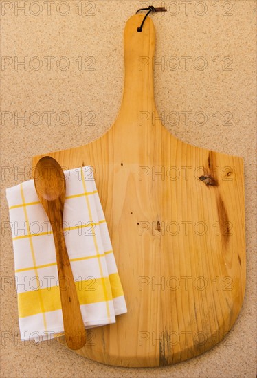 Wooden chopping board, spoon ad checked napkin. Photo : Daniel Grill