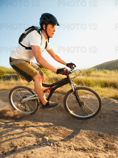 USA, California, Laguna Beach, Man cycling down hill.