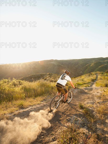 USA, California, Laguna Beach, Man cycling down hill.