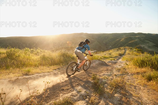 USA, California, Laguna Beach, Man cycling down hill.