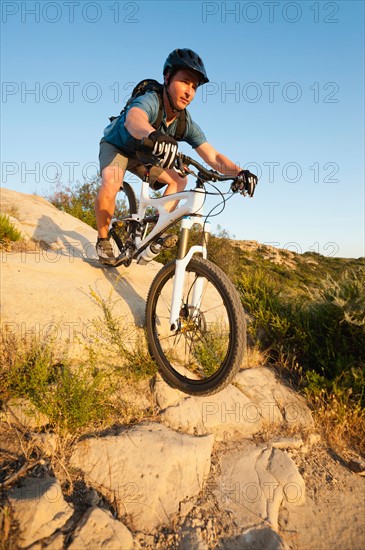 USA, California, Laguna Beach, Man cycling down hill.