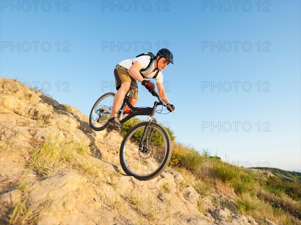 USA, California, Laguna Beach, Man cycling down hill.