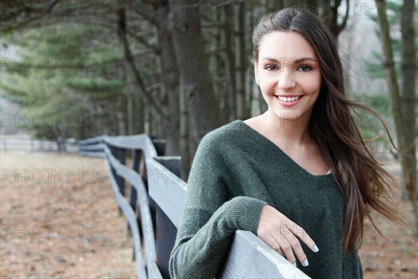 USA, New Jersey, Califon, Teenage girl (16-17) standing near fence and looking at camera, portrait. Photo : Pauline St.Denis