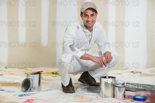 House painter stirring paint.