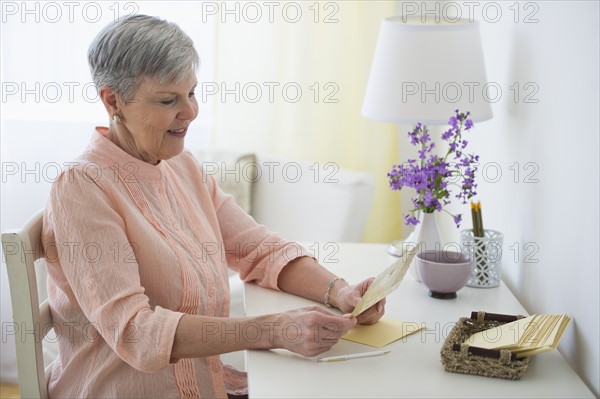 Senior woman writing letter.