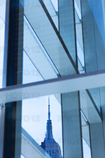 USA, New York, New York City, Empire State Building seen behind window frame.