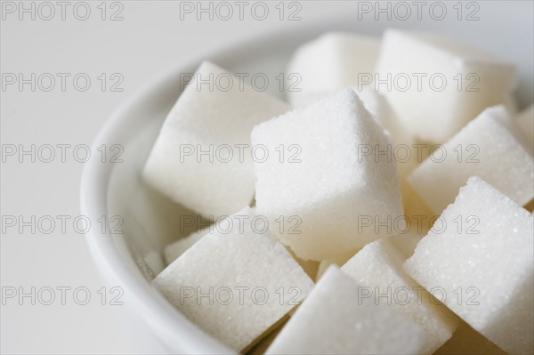 Studio shot of sugar cubes in bowl.