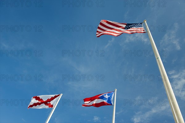 Puerto Rico, Old San Juan, low angle view of flags under blue sky.