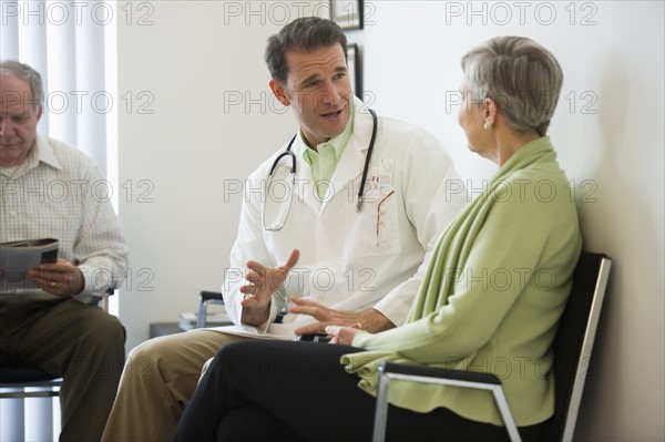 Senior couple talking to doctor.