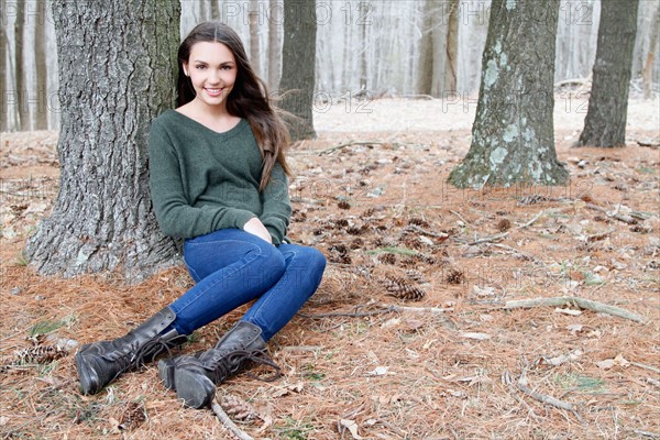 USA, New Jersey, Califon, Teenage girl (16-17) sitting in forest, portrait. Photo : Pauline St.Denis