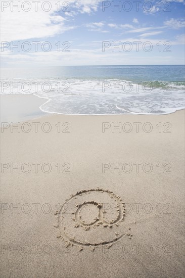 USA, Massachusetts, At sign drawn on sandy beach. Photo : Chris Hackett