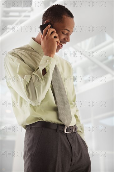 oung businessman using mobile phone . Photo : Mike Kemp