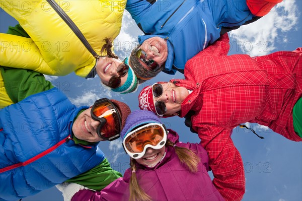 Three-generation family with girl (10-11) posing during ski holiday. Photo : db2stock