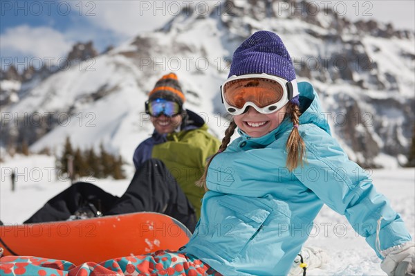 USA, Colorado, Telluride, Father and daughter (10-11) posing with snowboards in winter scenery. Photo : db2stock