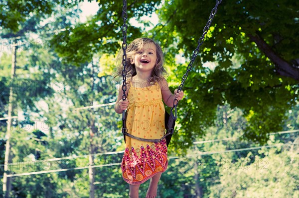 Girl (2-3) on swing in playground. Photo : King Lawrence