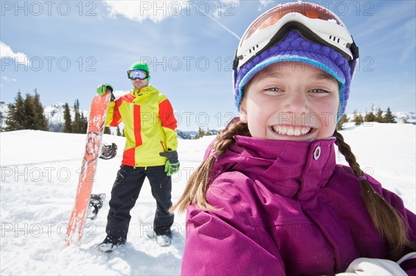 USA, Colorado, Telluride, Father and daughter (10-11) posing with snowboards in winter scenery. Photo : db2stock