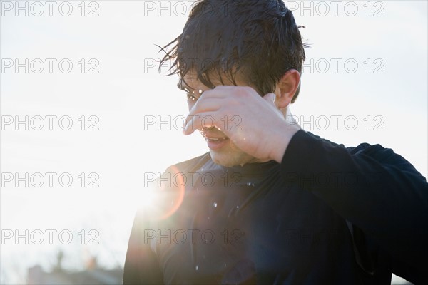 Man in sports clothing back lit by sun. Photo : Maisie Paterson