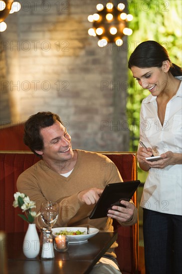 Man ordering food in restaurant.