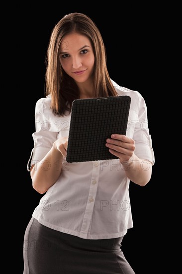 Young attractive businesswoman holding file. Photo : Mike Kemp