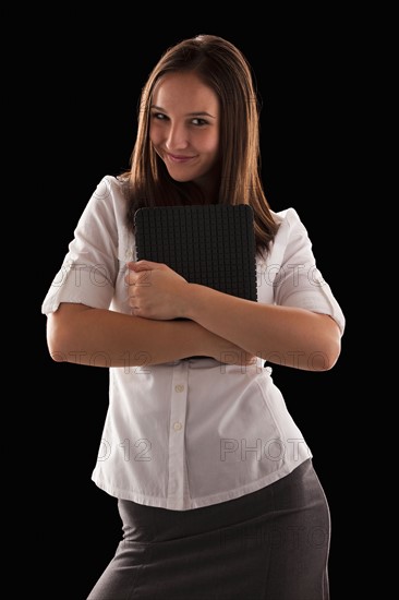 Young attractive businesswoman holding file. Photo : Mike Kemp