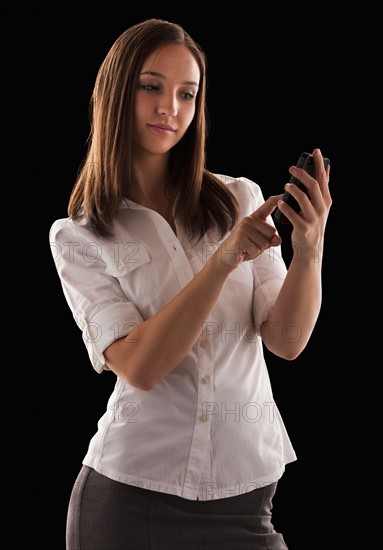 Young attractive businesswoman text messaging. Photo : Mike Kemp