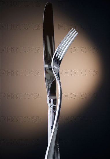 Close up of fork and knife on black background. Photo : Jamie Grill Photography