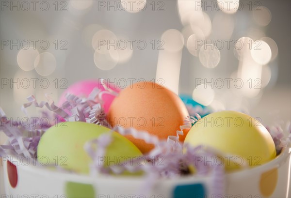 Colored Easter eggs in bowl, studio shot. Photo : Jamie Grill Photography