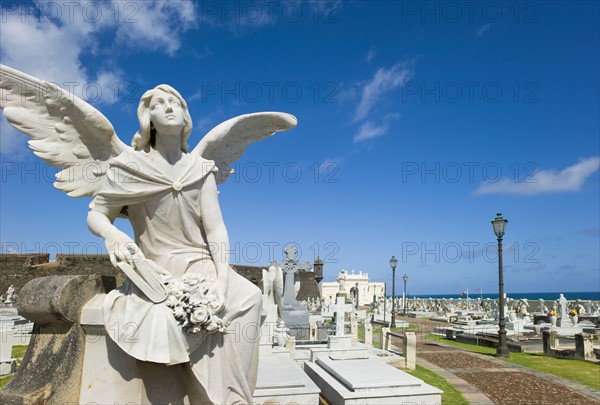 Puerto Rico, Old San Juan, Santa Maria Magdalena Cemetery with El Morro Fortress in background .