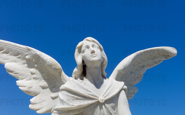 Puerto Rico, Old San Juan, Santa Maria Magdalena Cemetery, Close-up view of praying angel statue.