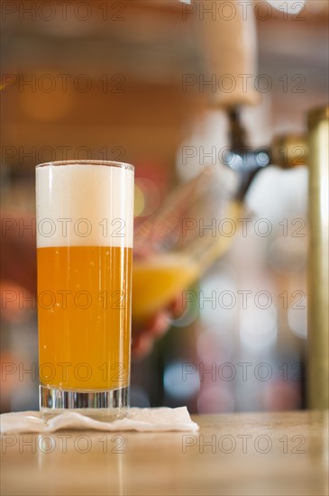 Pint of beer on bar counter.