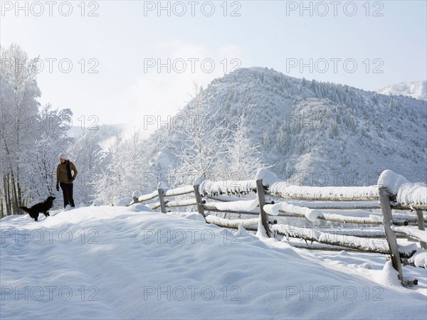 USA, Colorado, woman and dog in snowy ranch. Photo : John Kelly