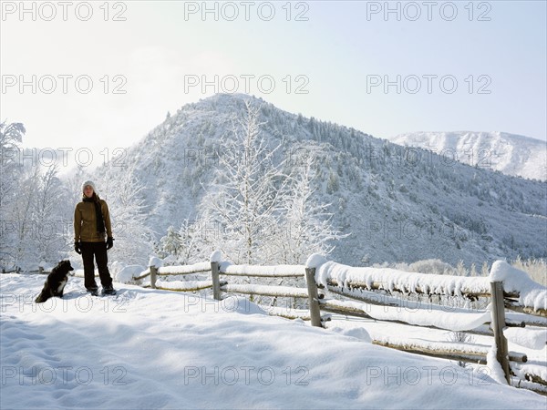 USA, Colorado, woman and dog in snowy ranch. Photo : John Kelly