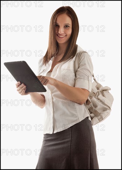 Young attractive businesswoman holding file. Photo : Mike Kemp