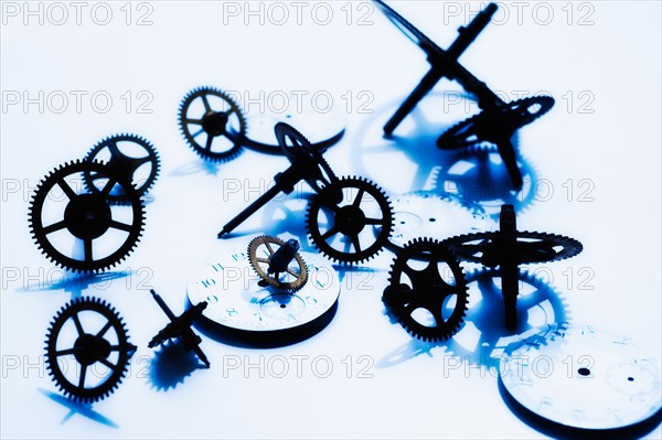 Close up of gears and clock parts on white background.