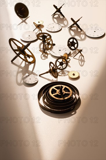 Close up of gears and clock parts on white background.