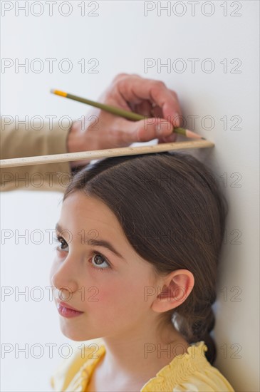 Girl (8-9) being measured.
