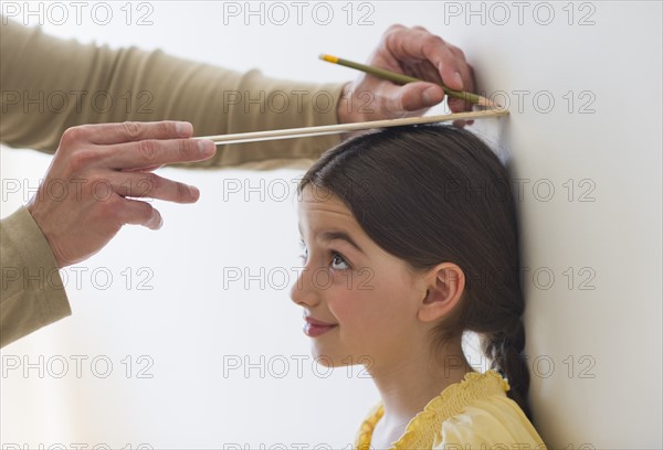 Girl (8-9) being measured.