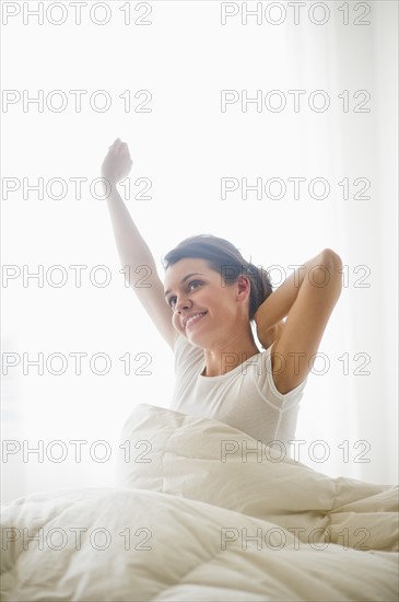 Happy young woman waking up.