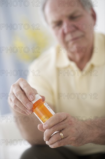 Portrait of senior man taking pills.