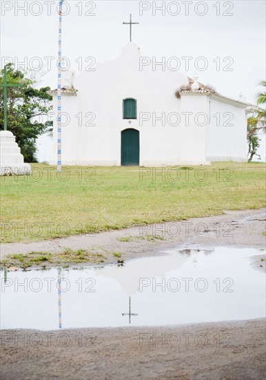 Brazil, Bahia, Trancoso, Church reflecting in puddle. Photo : Jamie Grill Photography