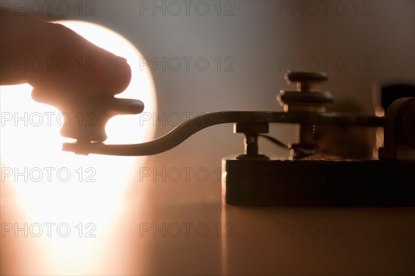 Close-up of man using telegraph key.