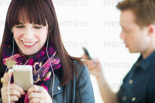 Two young people with mp3 players.