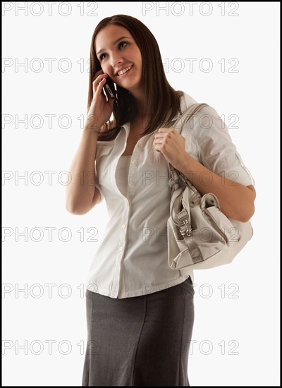 Young attractive businesswoman using mobile phone. Photo : Mike Kemp