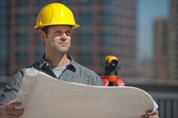 Worker holding blueprint.