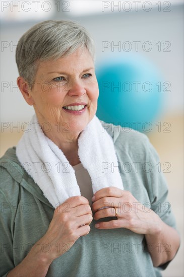 Smiling senior woman in gym.