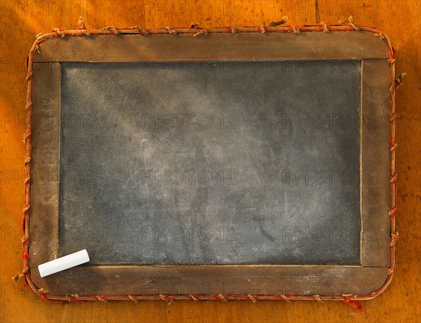 Empty chalkboard with chalk, studio shot. Photo : Daniel Grill
