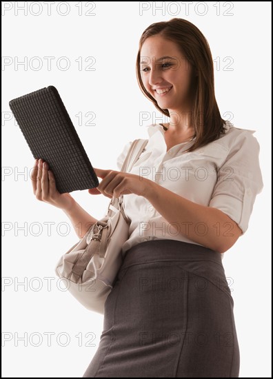 Studio shot of young woman with digital tablet. Photo : Mike Kemp