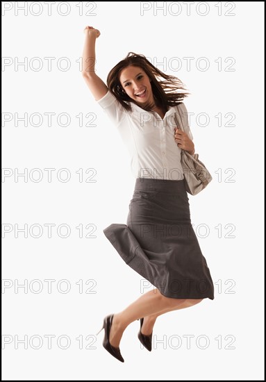 Studio shot of cheering woman. Photo : Mike Kemp