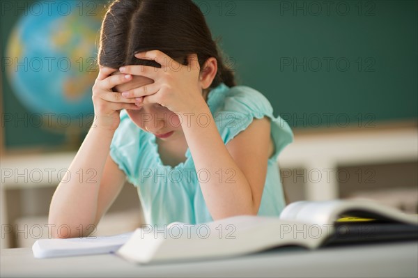 Schoolgirl (8-9) reading book.