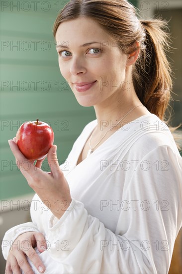 Portrait of expecting mother eating strawberries. Photo : Rob Lewine